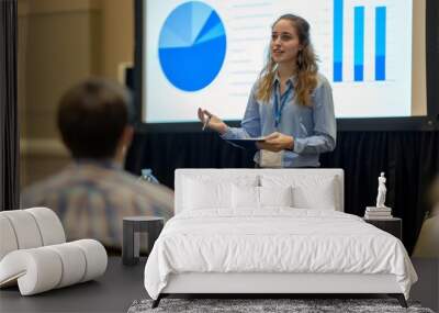 A woman stands before a group, giving a presentation on her research at a conference, A student presenting their research at a conference Wall mural