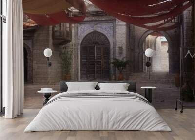 Empty shaded courtyard in a medieval Arabian city street with patches of sunlight. 3D rendering. Wall mural