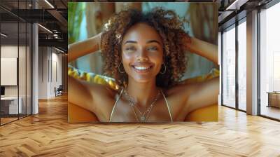 A happy Afro-American woman is dancing on the sofa at home, enjoying her day off while lying on the couch, reflecting a healthy lifestyle and good vibes. Wall mural