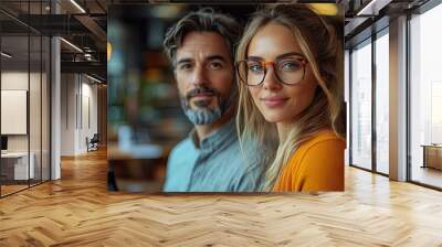 A man and woman collaborate in an office, using a laptop for data-driven web technology, brainstorming sessions, and collaborative problem-solving meetings. Wall mural