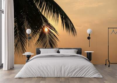 Palm tree leaf on orange sunset sky Wall mural