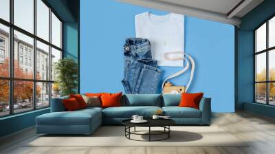 Childrens  White T-shirt with jeans. Baby clothes  for spring, autumn or summer on blue background. Fashion kids outfit. Flat lay, top view Wall mural