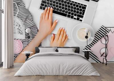 Fashion blogger working with laptop in bed, flat lay,  top view Wall mural