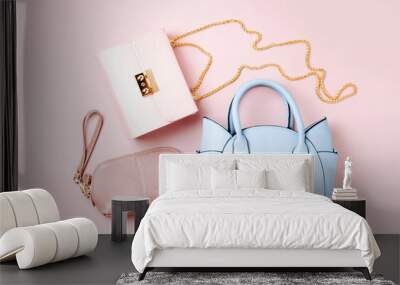 Fashion handbags on pale pink background. Flat lay, top view. Spring/summer fashion concept in pastel colored Wall mural