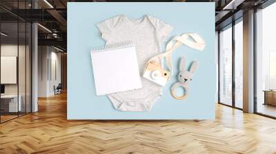 Gray cute baby bodysuit with mock up card. Set of kids clothes and accessories. Fashion newborn. Flat lay, top view Wall mural