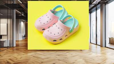 Pink kids clogs beach slippers on yellow background. Summer vacation concept. Fashion Sandals Beach Flip-Flops Wall mural