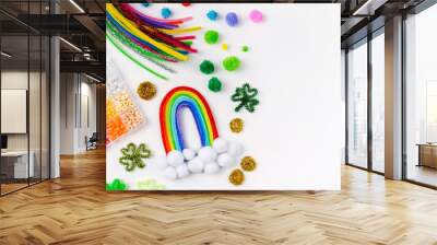 Rainbow and clover made of beads and pipe cleaners with different multi-colored  materials for DIY art activity for kids. Cute children's crafts of St Patrick's Day. Creativity and hobby. Wall mural