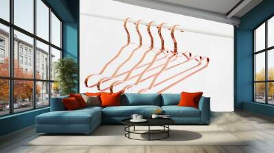 Rose gold clothes hangers on a rod on white background. Empty hanger. Fashion, sale concept. Wall mural