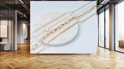 Trendy jewelry with chains and pearl necklace. Stylish golden bijouterie. Fashion accessories. Wall mural