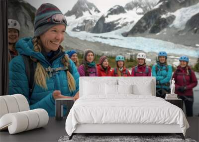 A group of women are posing for a picture in the snow. One woman is wearing a blue jacket and a hat Wall mural