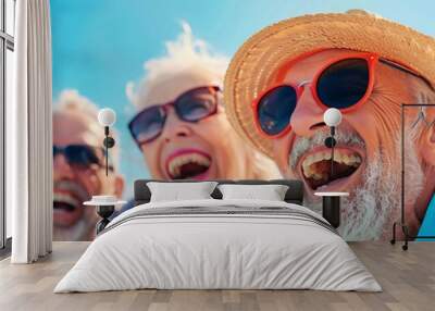 A group of happy senior people with sunglasses laughing and having fun at the beach on a sunny day Wall mural