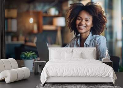 a young smiling businesswoman working on her laptop in an office Wall mural