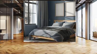 Cozy modern bedroom with a wooden bed frame, soft grey bedding, and two framed mock-up poster frames on a navy blue accent wall, bathed in natural sunlight Wall mural