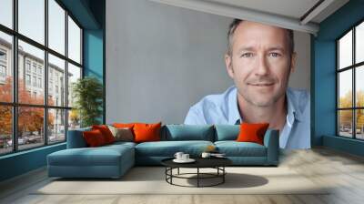 Portrait of middle aged man wearing a blue shirt Wall mural