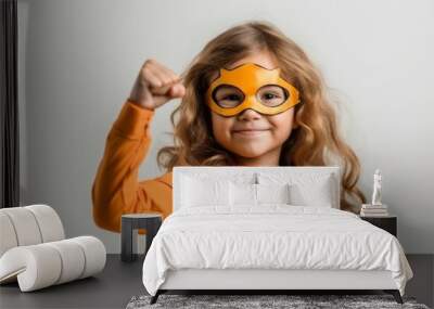 adorable little girl in superhero costume showing biceps isolated on grey Wall mural