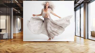 Full length portrait of a happy mature woman dancing isolated on a white background Wall mural