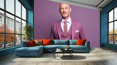 Portrait of a bald man in a pink suit on a purple background Wall mural