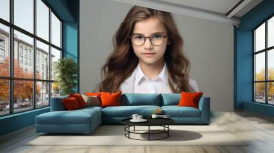 Portrait of a beautiful young girl in glasses. Isolated on gray background. Wall mural