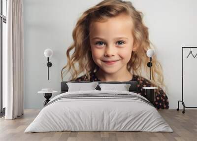 Portrait of a cute little girl with curly hair on a white background Wall mural