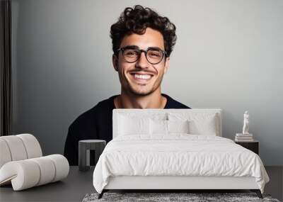 Portrait of a handsome young man wearing glasses and looking at camera. Wall mural