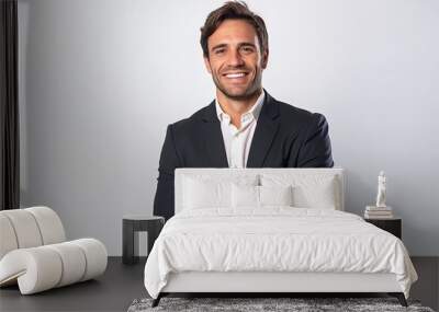 Portrait of a happy businessman standing with arms crossed against white background Wall mural