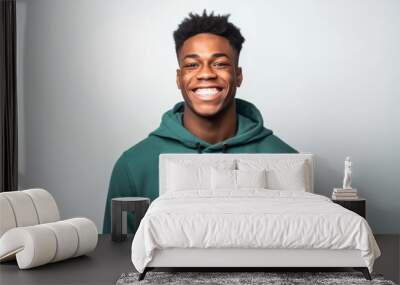 Portrait of a smiling african american man in green hoodie Wall mural