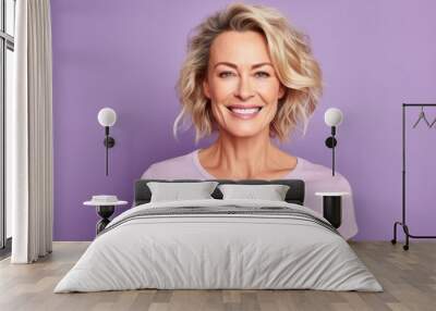 Portrait of a smiling woman with blonde hair on a purple background Wall mural