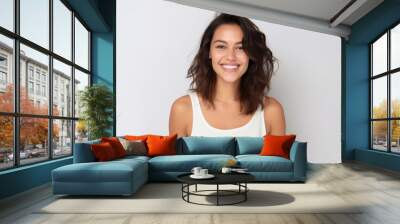 Portrait of beautiful young woman smiling and looking at camera on white background Wall mural