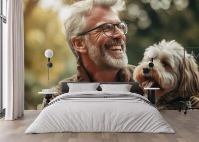 Portrait of happy senior man in eyeglasses with dog in park Wall mural