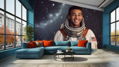 Portrait of happy young man in astronaut suit against dark background with falling snow Wall mural