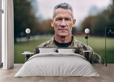 portrait of mature soldier in military uniform looking at camera in park Wall mural