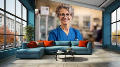 Portrait of smiling female doctor standing with arms crossed in hospital corridor Wall mural