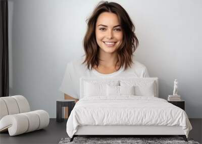 Portrait of young beautiful woman in white t-shirt looking at camera Wall mural