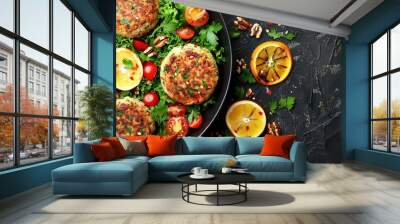   A close-up photo of a dish with juicy meat patties and vibrant veggies on a black backdrop, accentuated by orange slices, ripe tomatoes, Wall mural