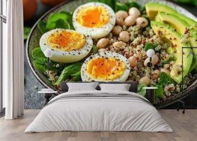   Bowl of eggs, spinach, beans, and avocado on a black table Wall mural