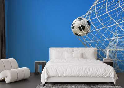  Soccer ball in soccer goal net in a big stadium isolated on blue sky. soccer net. Wall mural