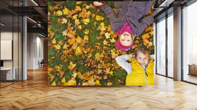 a smiling children enjoys the golden autumn colors Wall mural