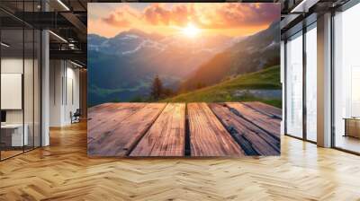 An empty wooden table overlooks a breathtaking alpine landscape at sunset Wall mural