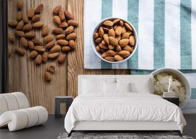  nuts in bowl on a wooden background. Rustic style. Almonds on a towel. Vegetarian food. Wall mural