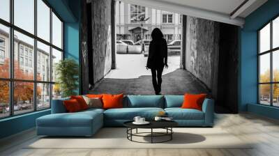 black and white photo, silhouette of a girl in the architectural arch of the tunnel Wall mural