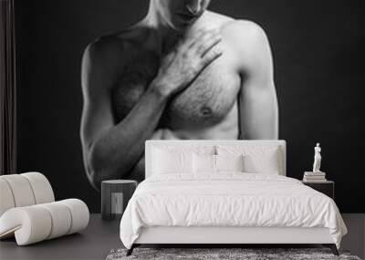 Full length portrait of a sexy young man in jeans and shirtless posing at studio. Wall mural