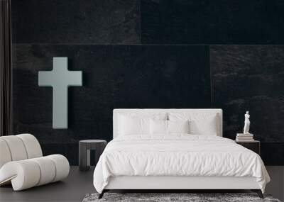 Christian cross on a textured black background. Religion concept. Blue cross Wall mural