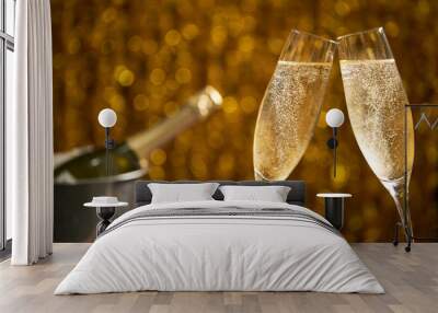 Glasses of champagne on a golden background, party or holiday concept Wall mural