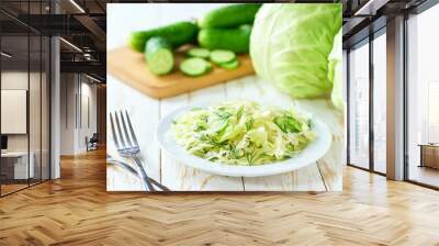 homemade salad of cabbage,cucumber and dill on a white wooden table, selective focus. Vegan or diet food. Wall mural