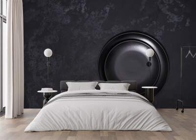 Two empty black plates on a black background, top view. Wall mural