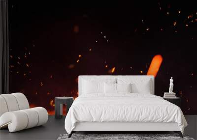 Fire embers particles over black panorama background. Fire burn sparks background. Abstract dark glitter fire particles lights. Wall mural