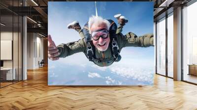 Funny and smiling elderly man has fun skydiving Wall mural