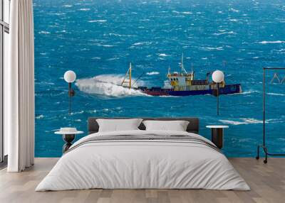 Fishing boat in rough weather Wall mural