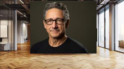 Handsome middle aged man with glasses and a black t-shirt Wall mural