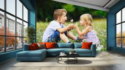 happy children play outdoor with the dandelions Wall mural